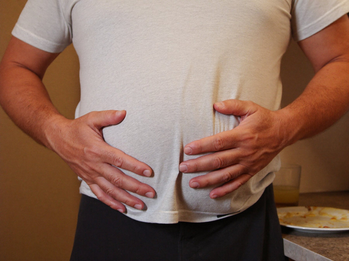 Hands pressed against a swollen stomach Image