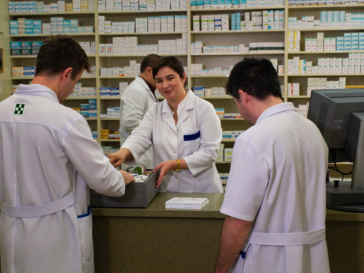 Pharmacists behind the counter Image
