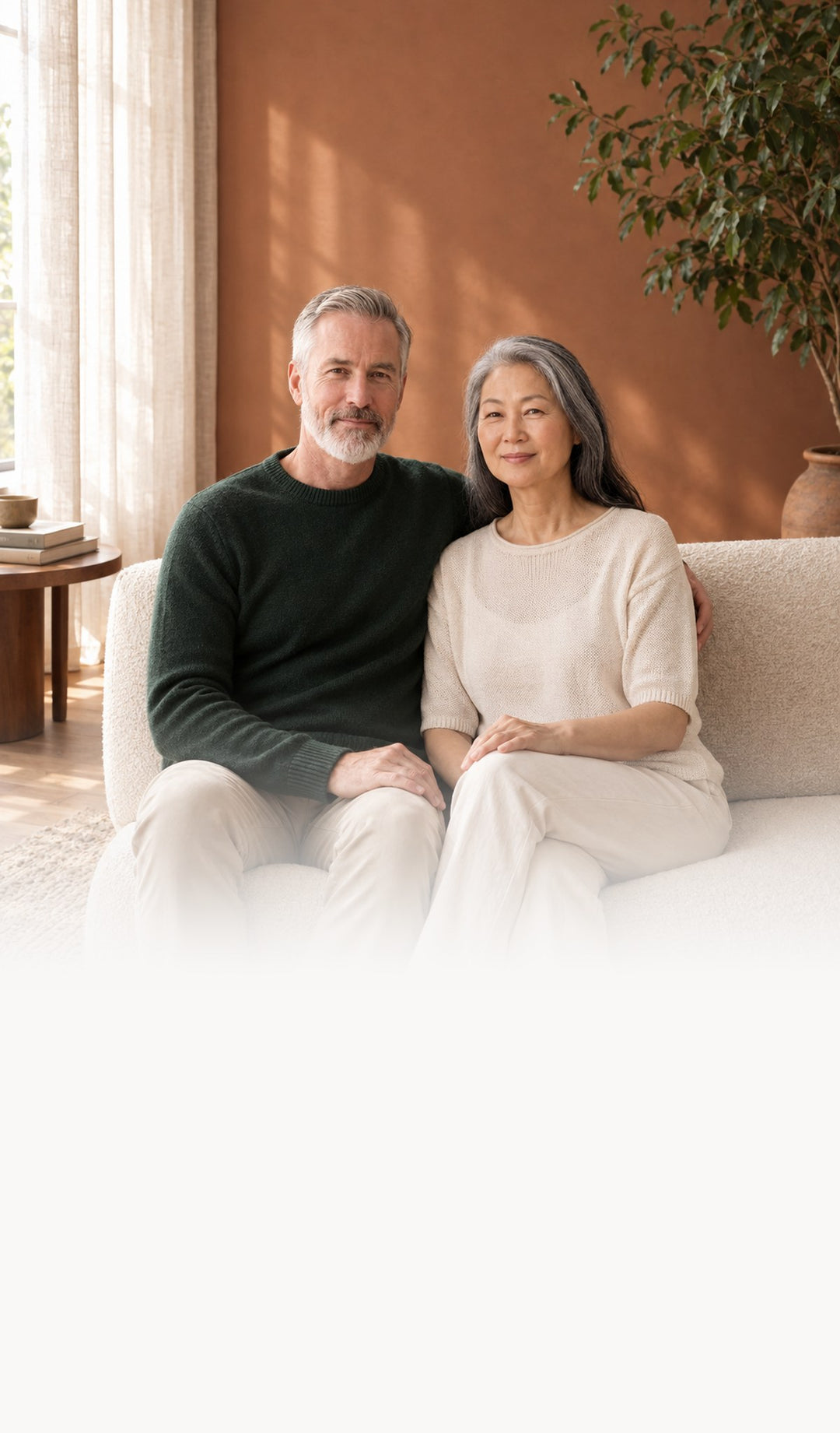 A couple sitting together at home in a warm living room