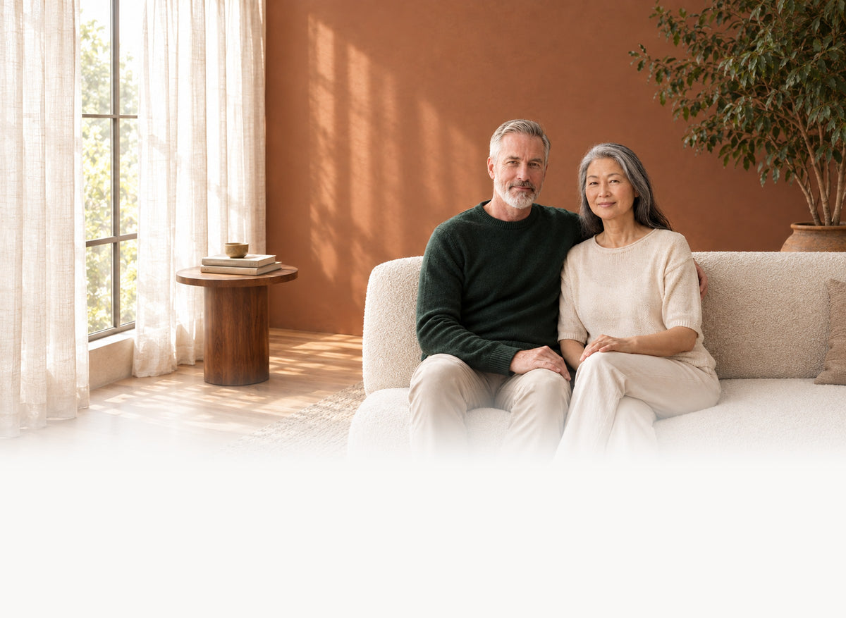 A couple sitting together at home in a warm living room